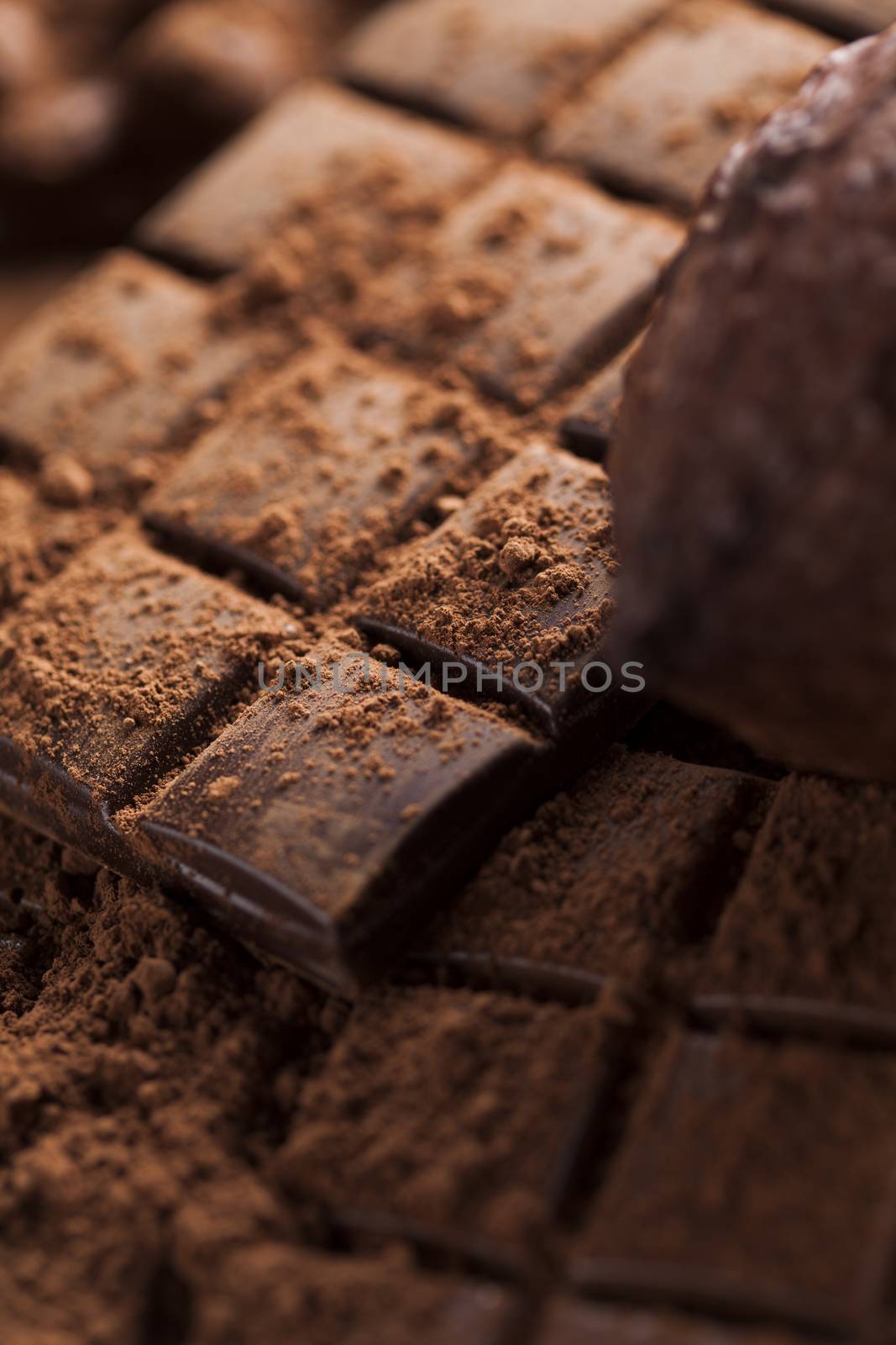 Dark and milk chocolate bar on a wooden table  by JanPietruszka