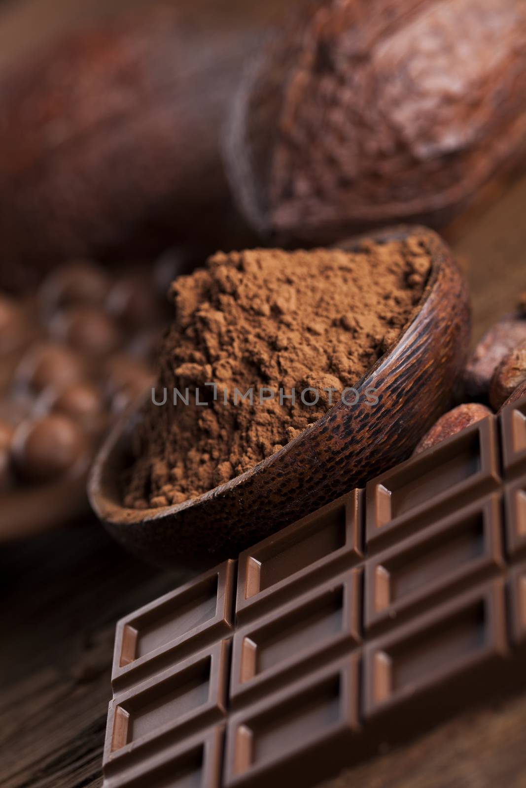 Aromatic cocoa and chocolate on wooden background