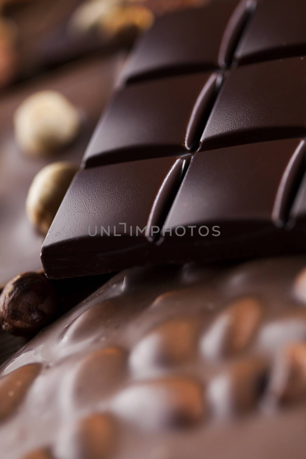 Dark homemade chocolate bars and cocoa pod on wooden  by JanPietruszka