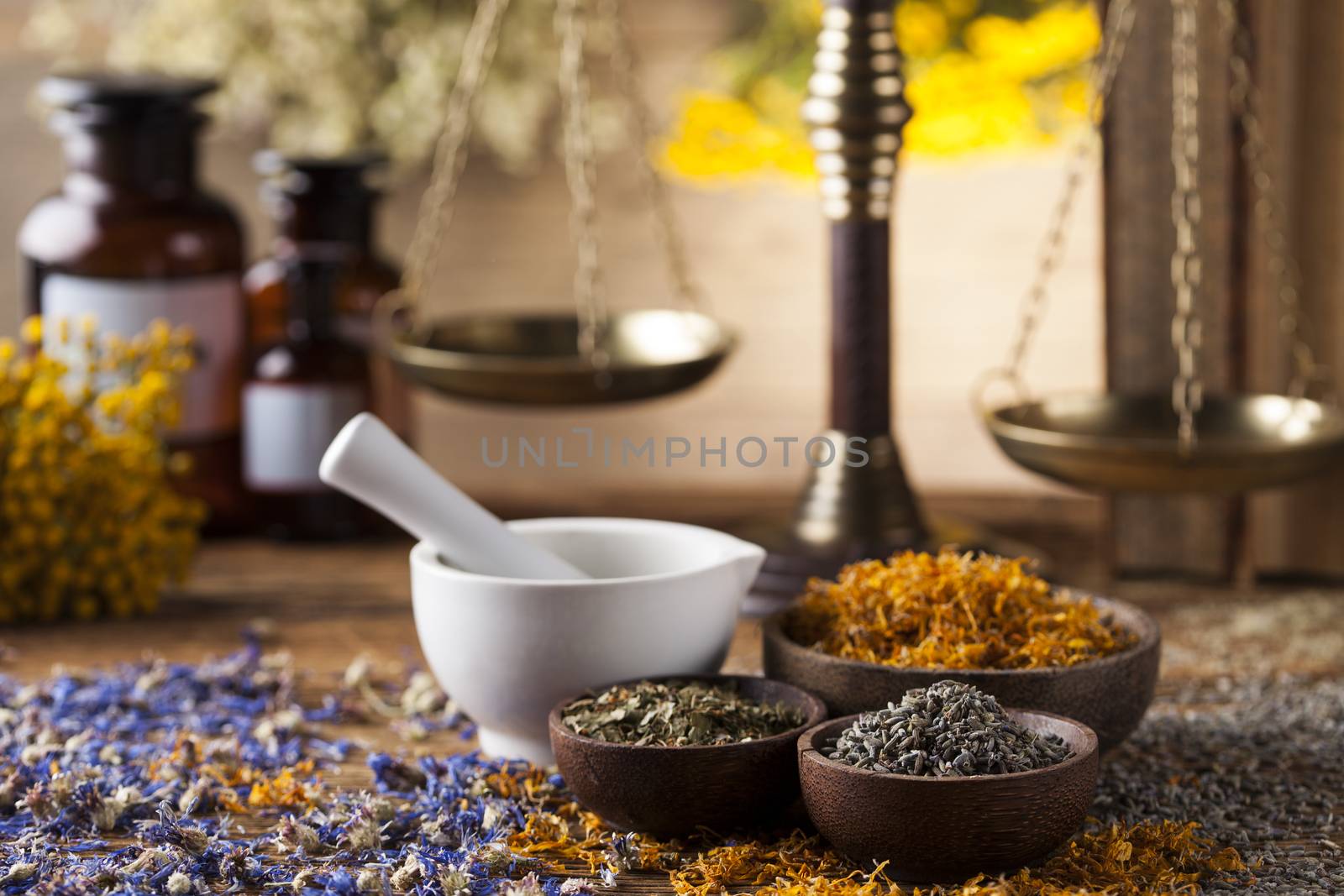 Herbs, berries and flowers with mortar, on wooden table backgrou by JanPietruszka