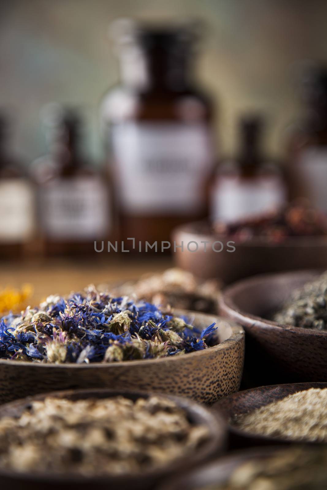 Herbs medicine and vintage wooden desk background by JanPietruszka