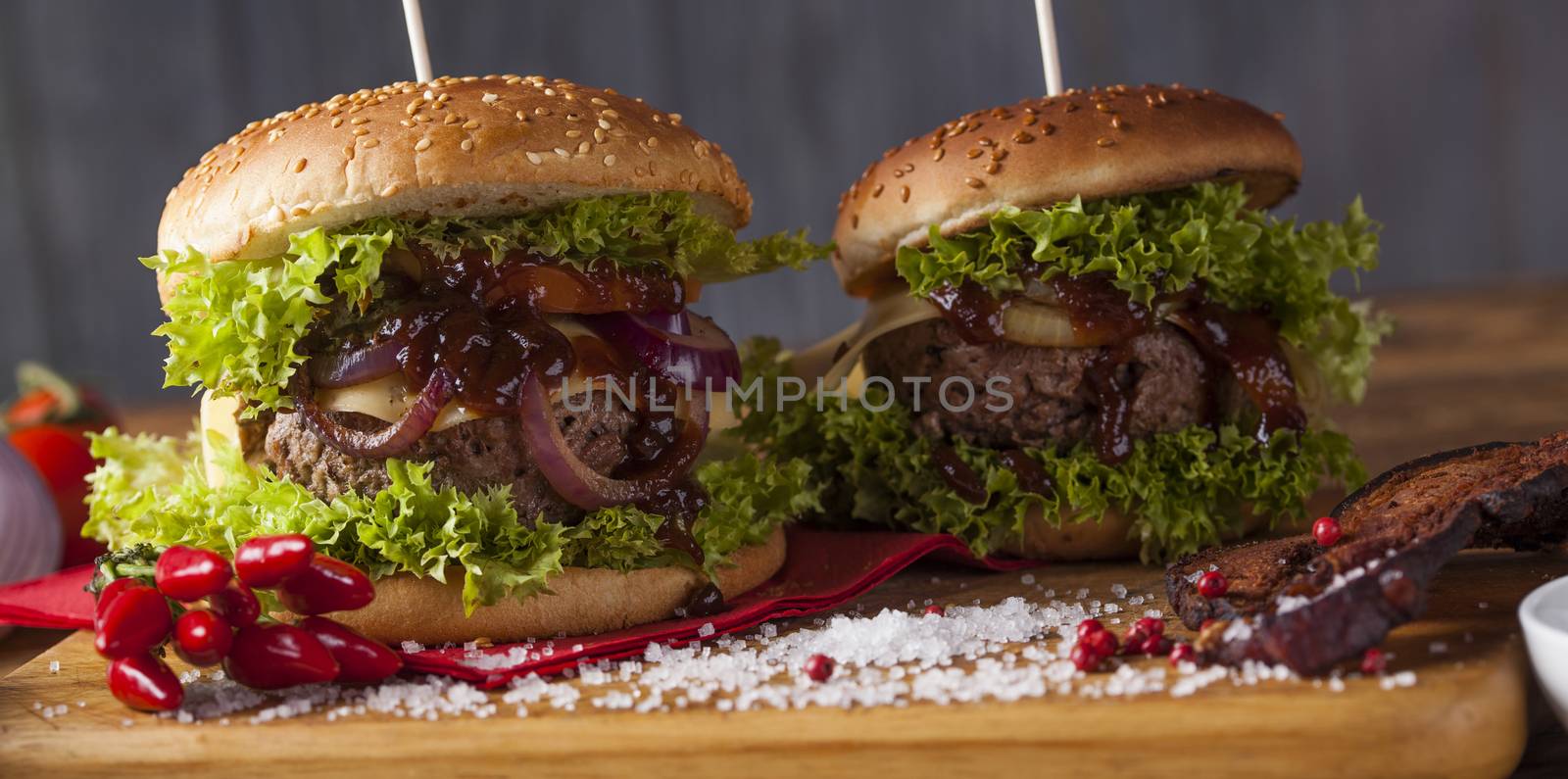 Close-up of home made burgers, wooden desk background by JanPietruszka
