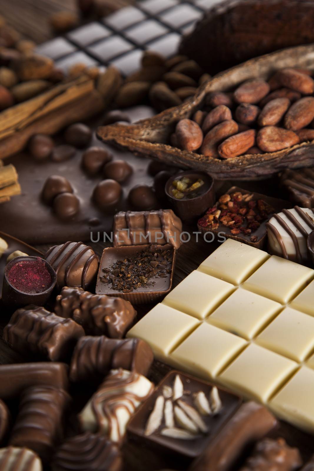 Dark and milk chocolate bar on a wooden table  by JanPietruszka