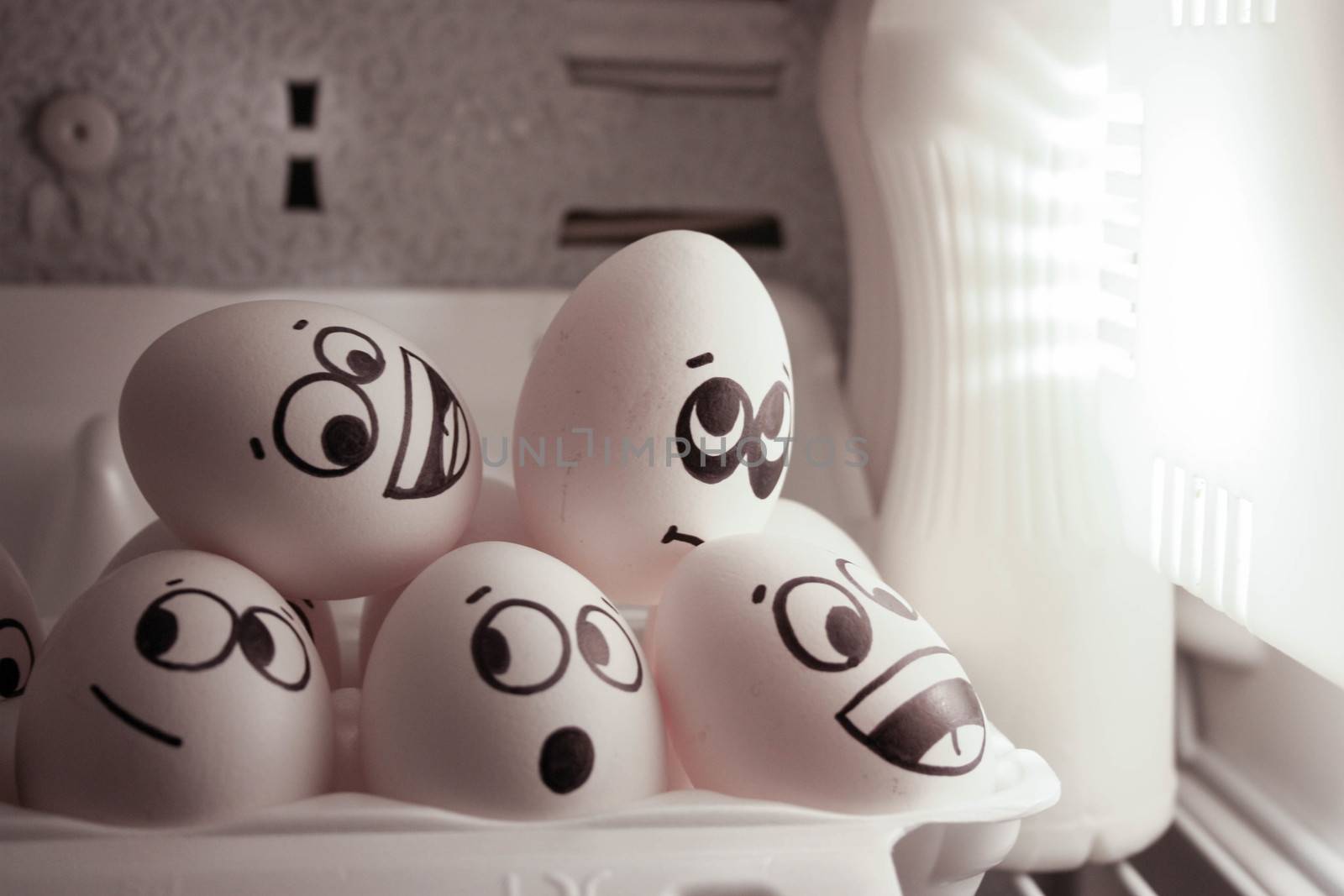 Concept of enlightening ideas. Eggs in the refrigerator near the lamp. Collective insight. Photo for your design.