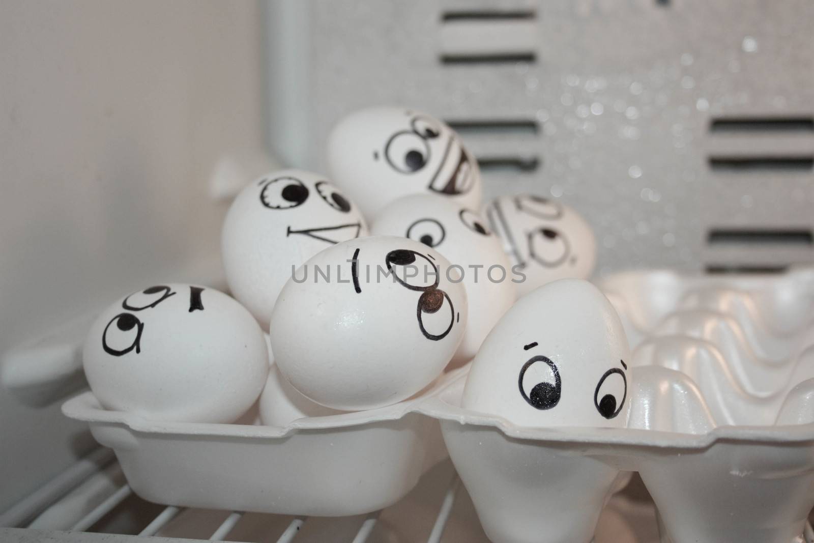 Concept of refugees. Funny eggs a bunch of each other. Photo for your design. Eggs in a container in the refrigerator.