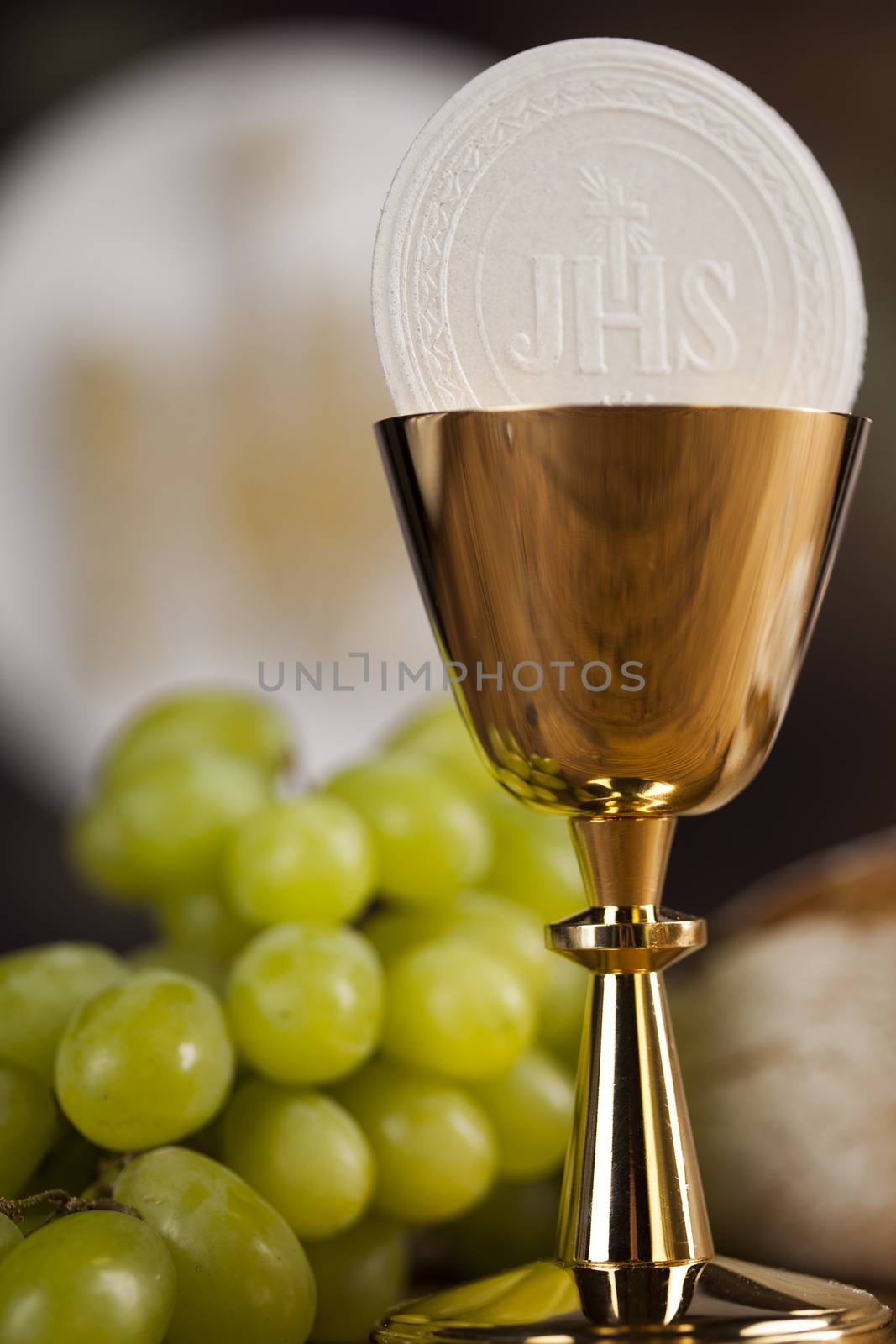 Holy communion a golden chalice with grapes and bread wafers by JanPietruszka