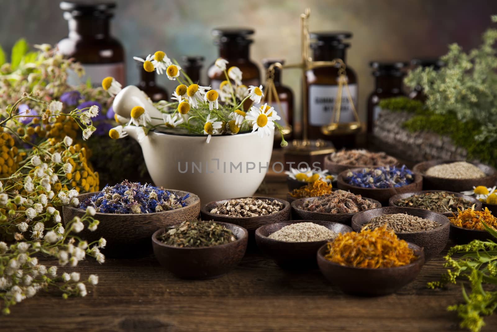 Healing herbs on wooden table, mortar and herbal medicine  by JanPietruszka