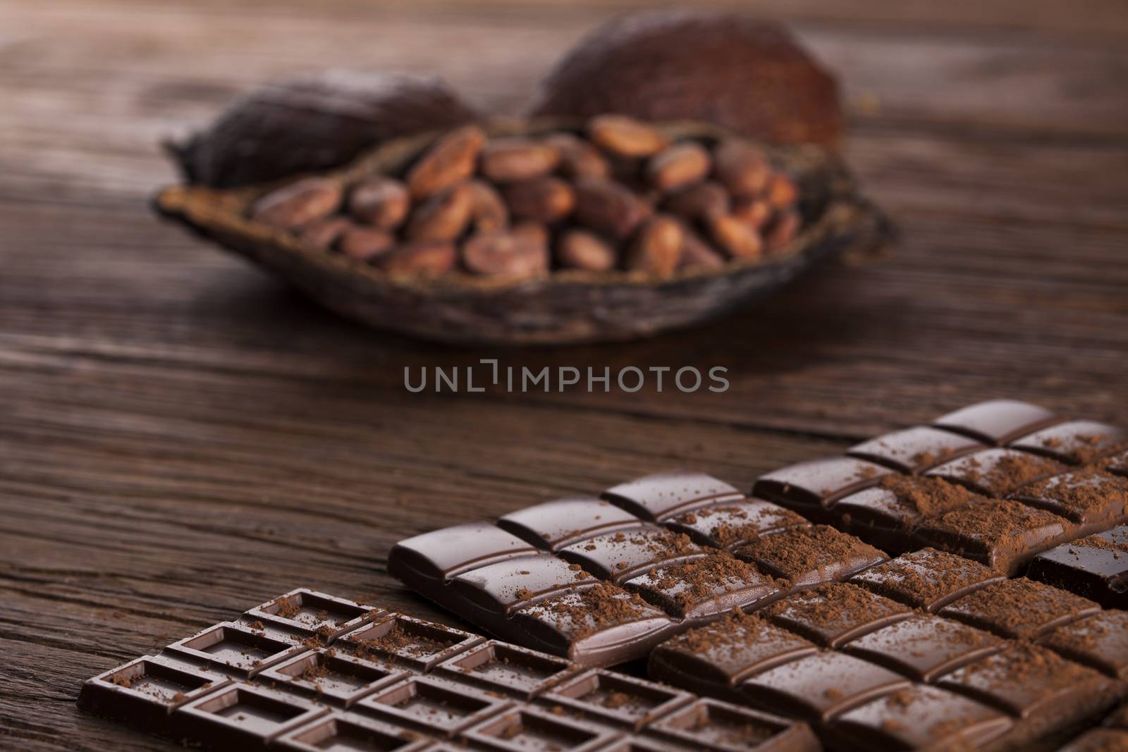 Dark and milk chocolate bar on a wooden table  by JanPietruszka