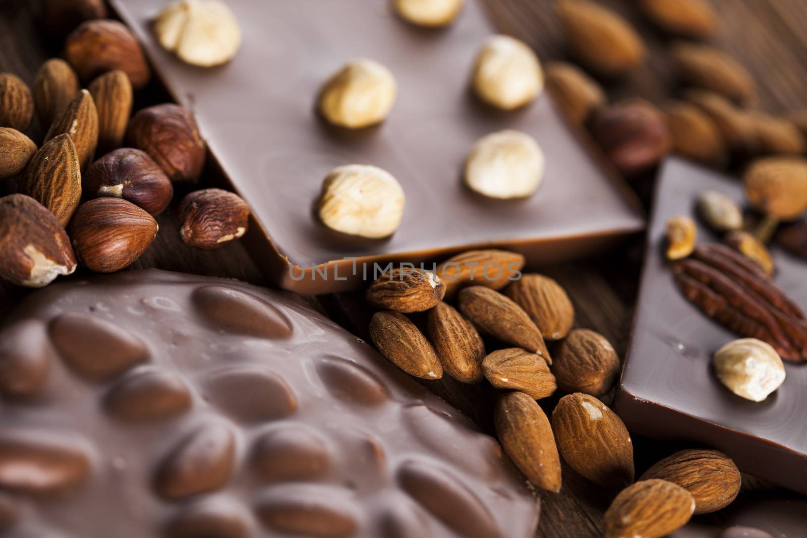 Dark homemade chocolate bars and cocoa pod on wooden  by JanPietruszka