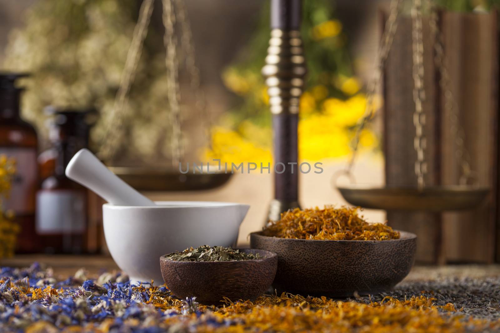 Herbs, berries and flowers with mortar, on wooden table backgrou by JanPietruszka