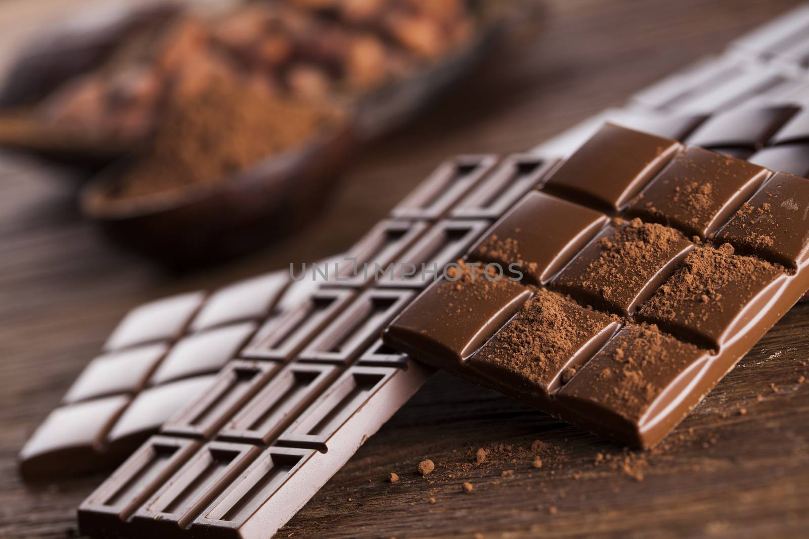 Aromatic cocoa and chocolate on wooden background