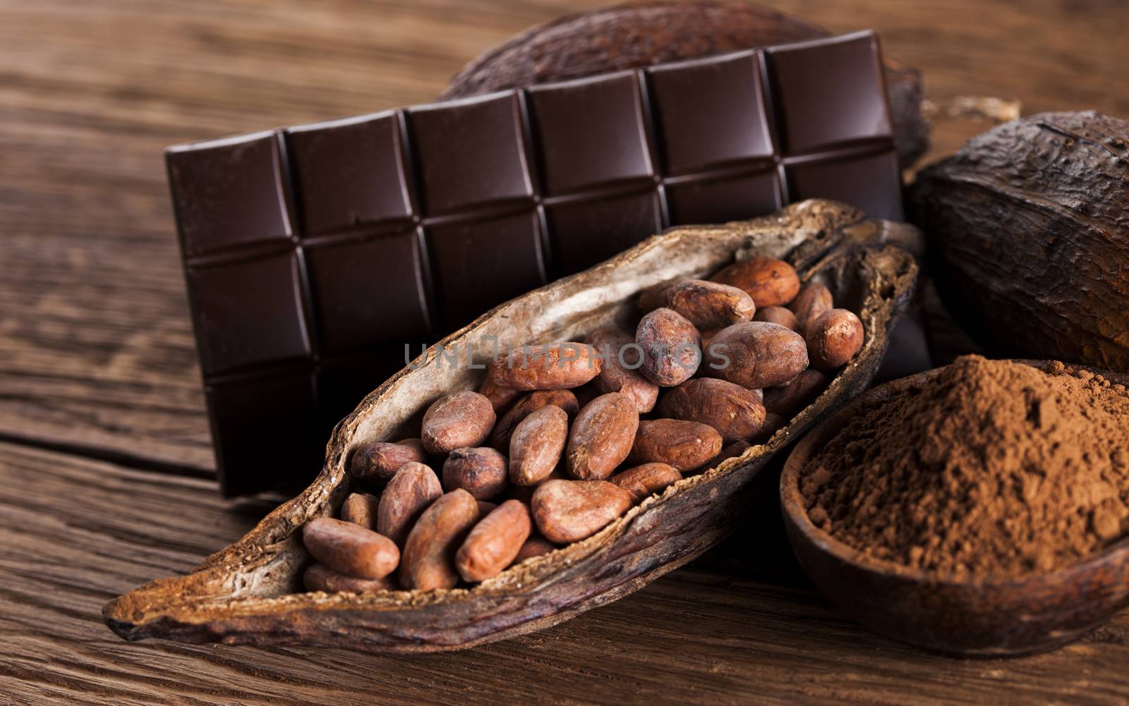 Aromatic cocoa and chocolate on wooden background