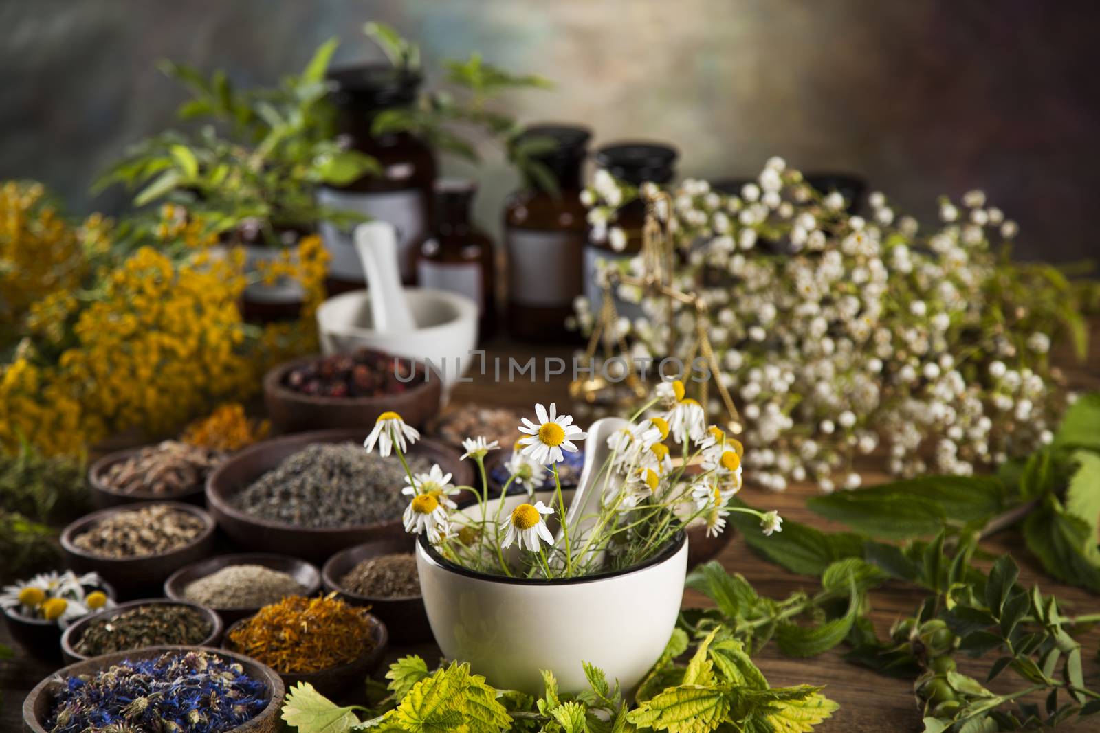 Alternative medicine, dried herbs and mortar on wooden desk back by JanPietruszka