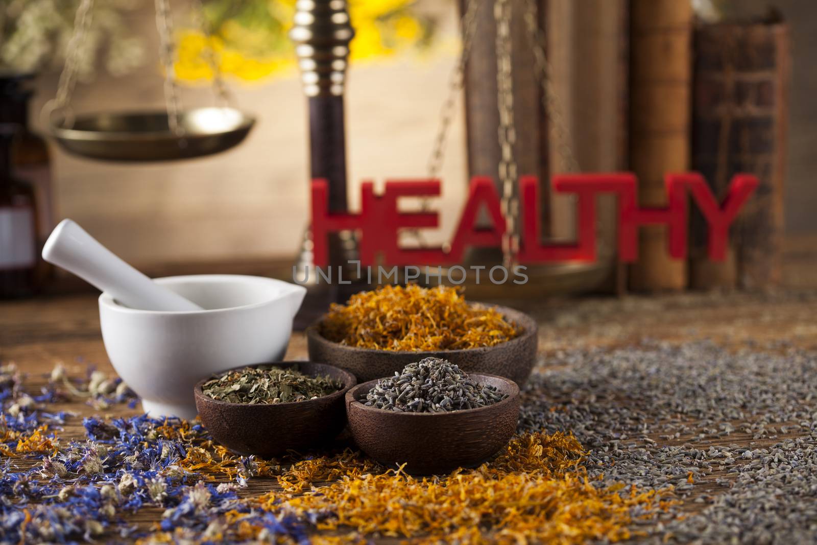 Healthy herbs on wooden table, mortar and herbal medicine  by JanPietruszka