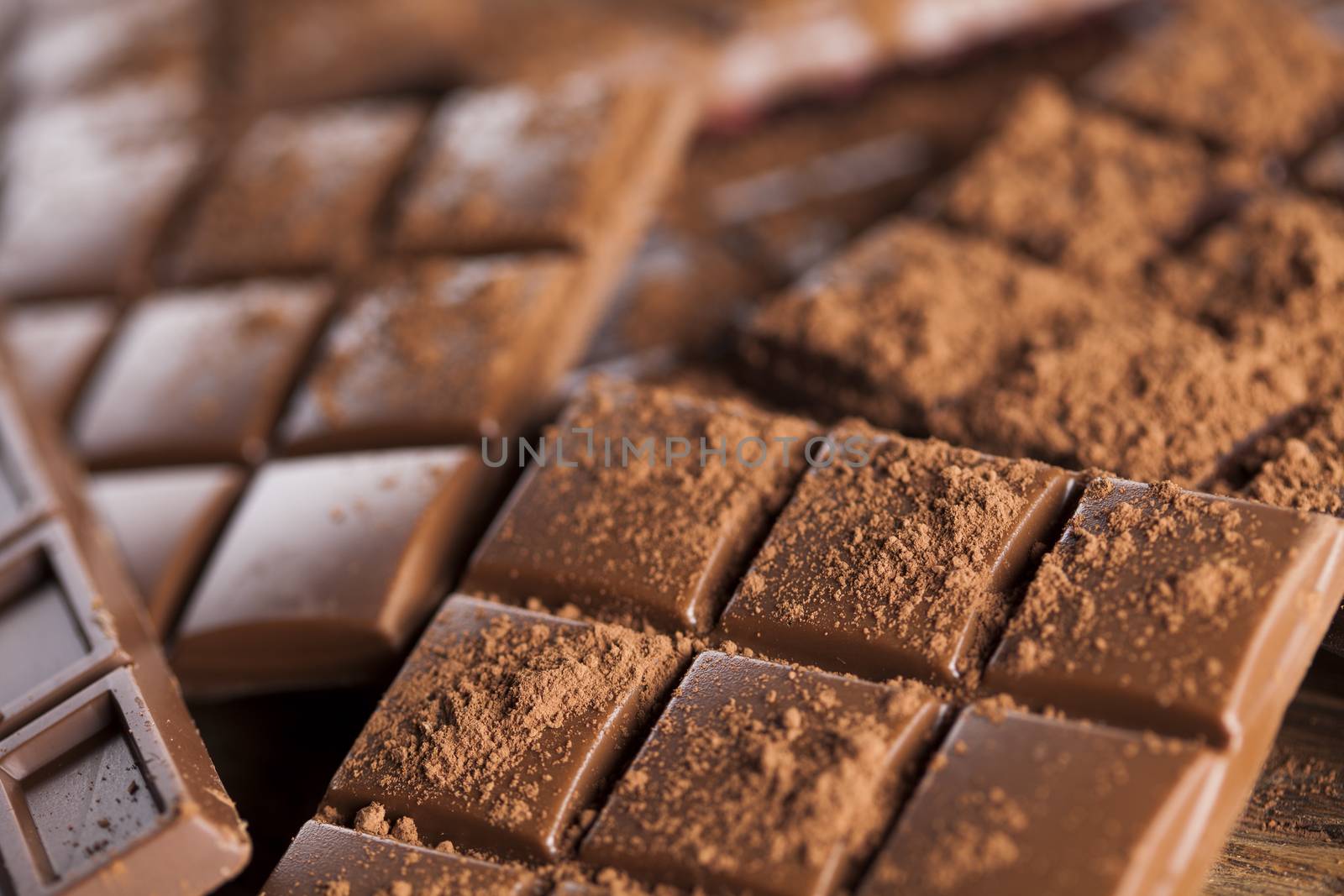 Dark homemade chocolate bars and cocoa pod on wooden  by JanPietruszka