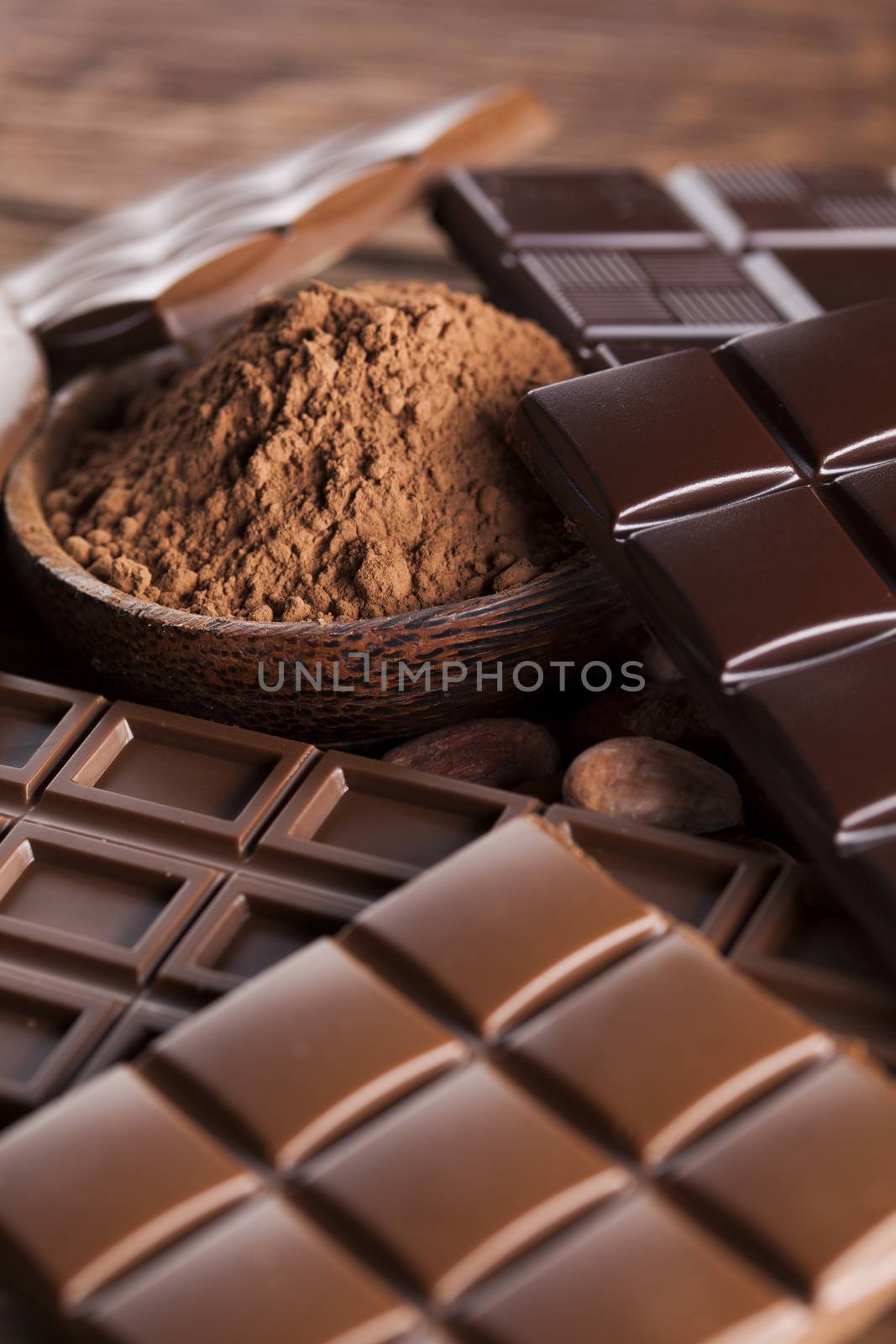 Aromatic cocoa and chocolate on wooden background