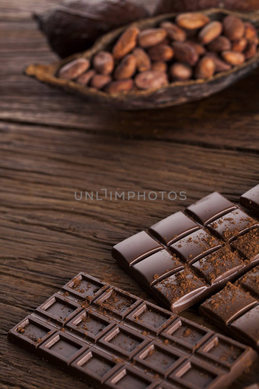 Aromatic cocoa and chocolate on wooden background