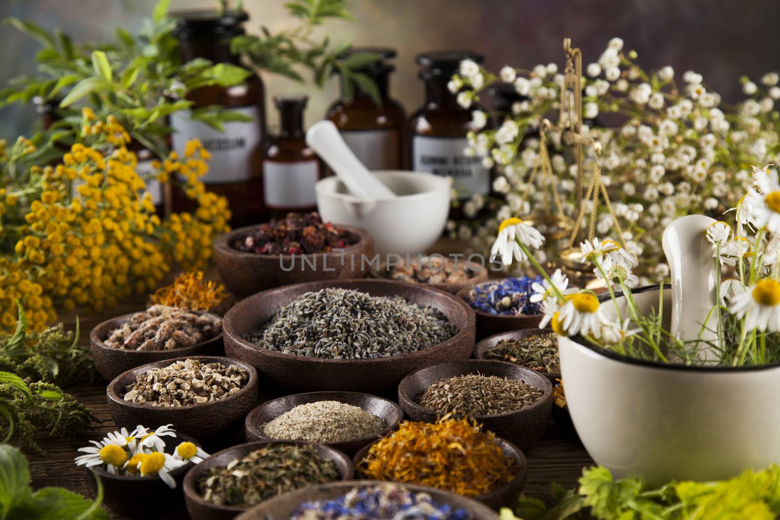 Alternative medicine, dried herbs and mortar on wooden desk back by JanPietruszka