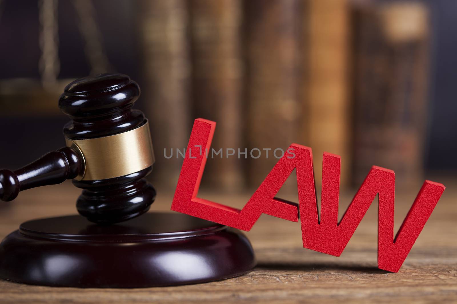 Law theme, mallet of the judge, justice scale, wooden desk background