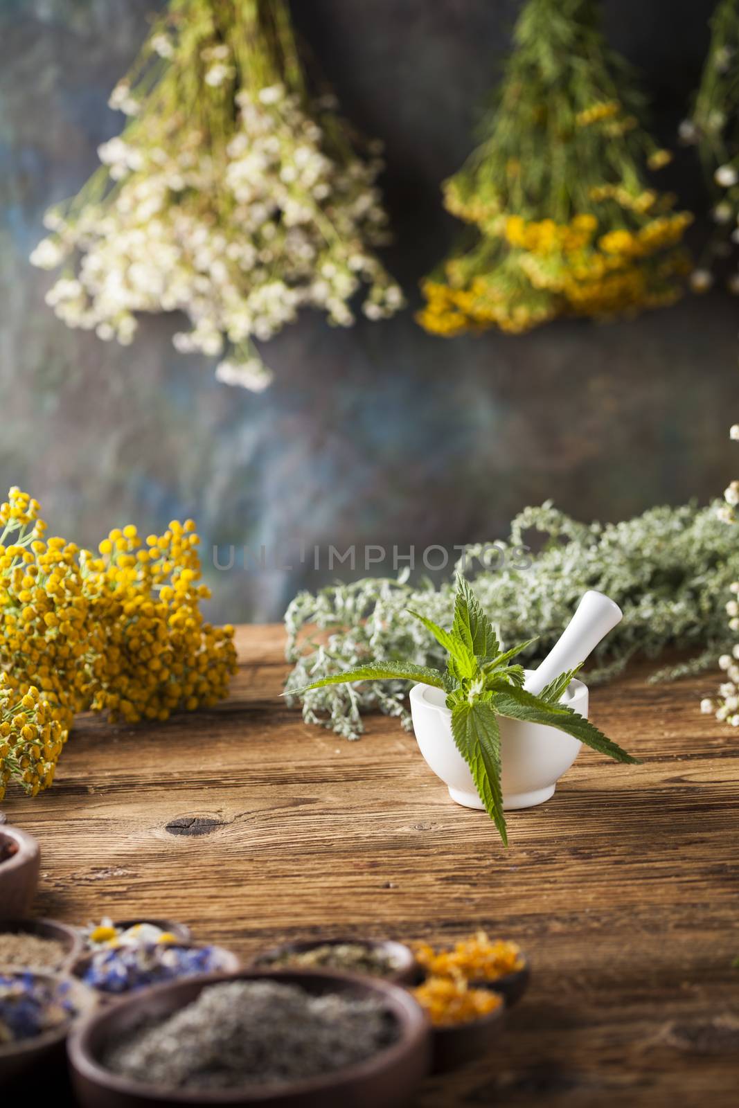 Herbs medicine,Natural remedy and mortar on vintage wooden desk  by JanPietruszka