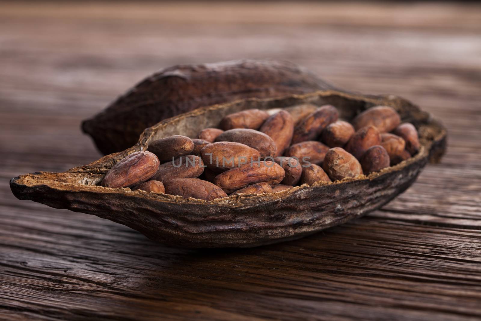 Cocoa pod on wooden background by JanPietruszka