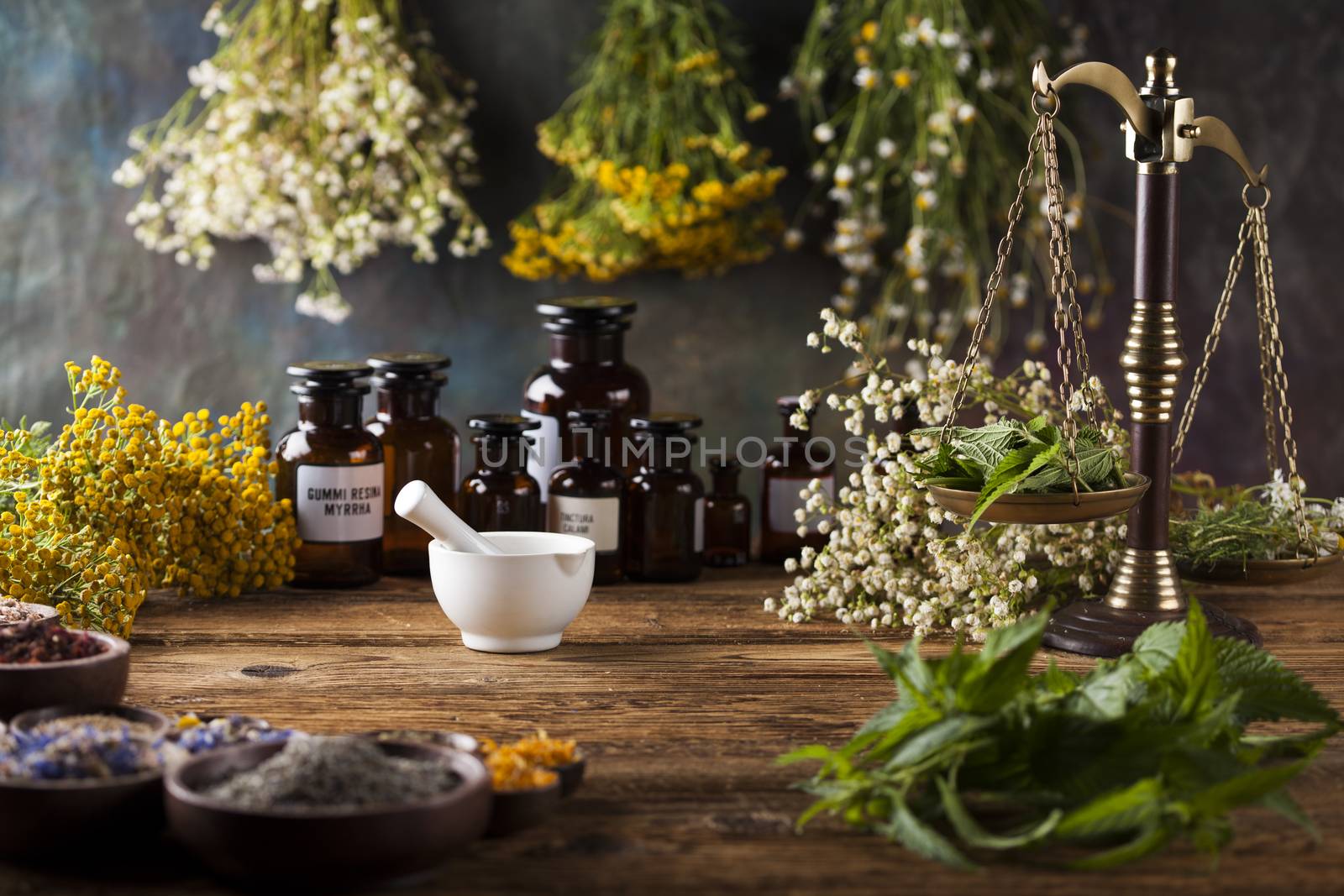 Herbs medicine,Natural remedy and mortar on vintage wooden desk  by JanPietruszka