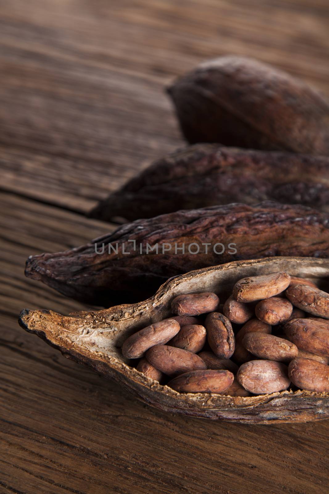 Cocoa pod on wooden background by JanPietruszka