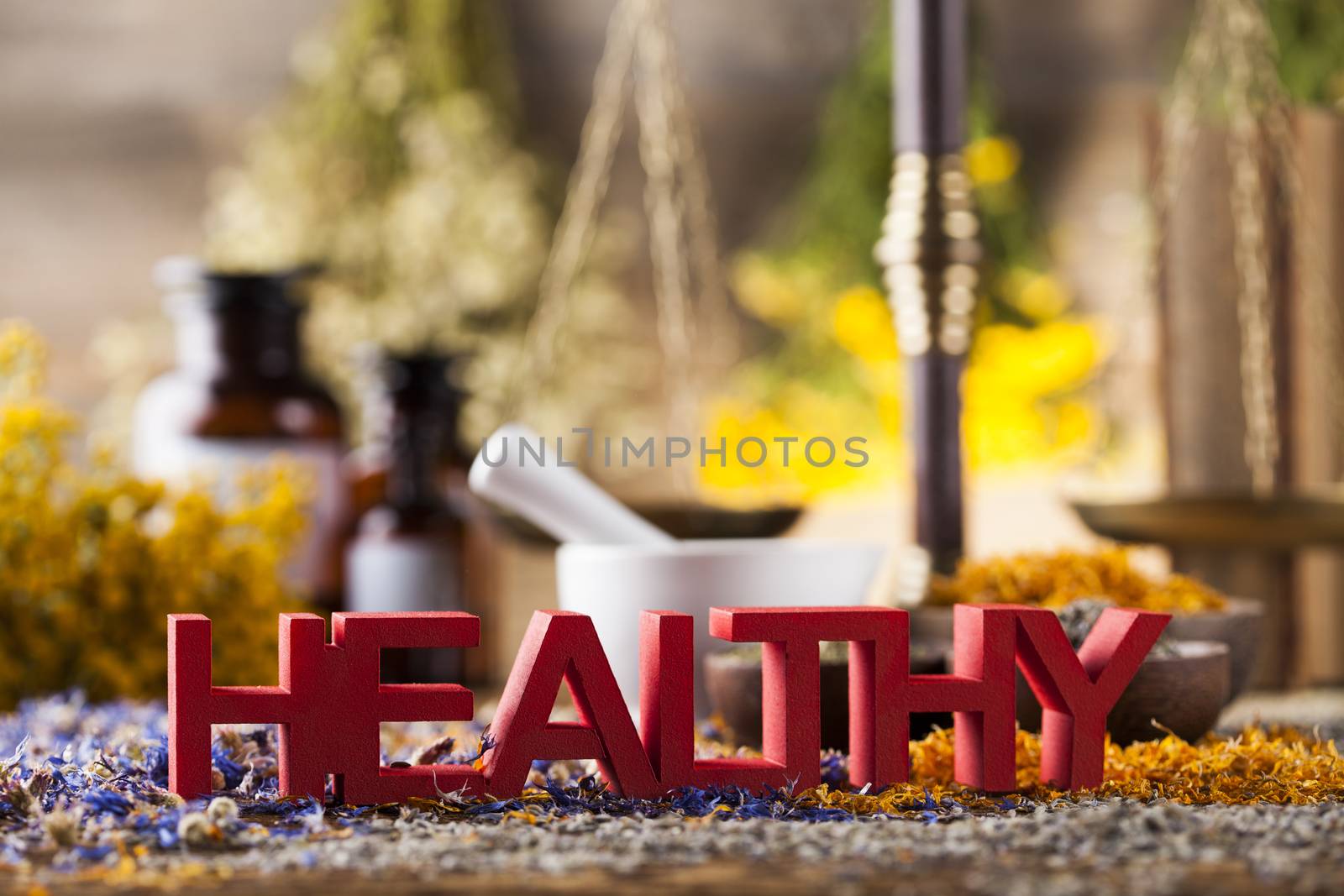 Healthy herbs on wooden table, mortar and herbal medicine  by JanPietruszka