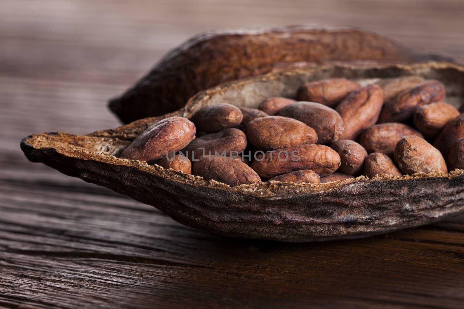 Cocoa pod on wooden background by JanPietruszka