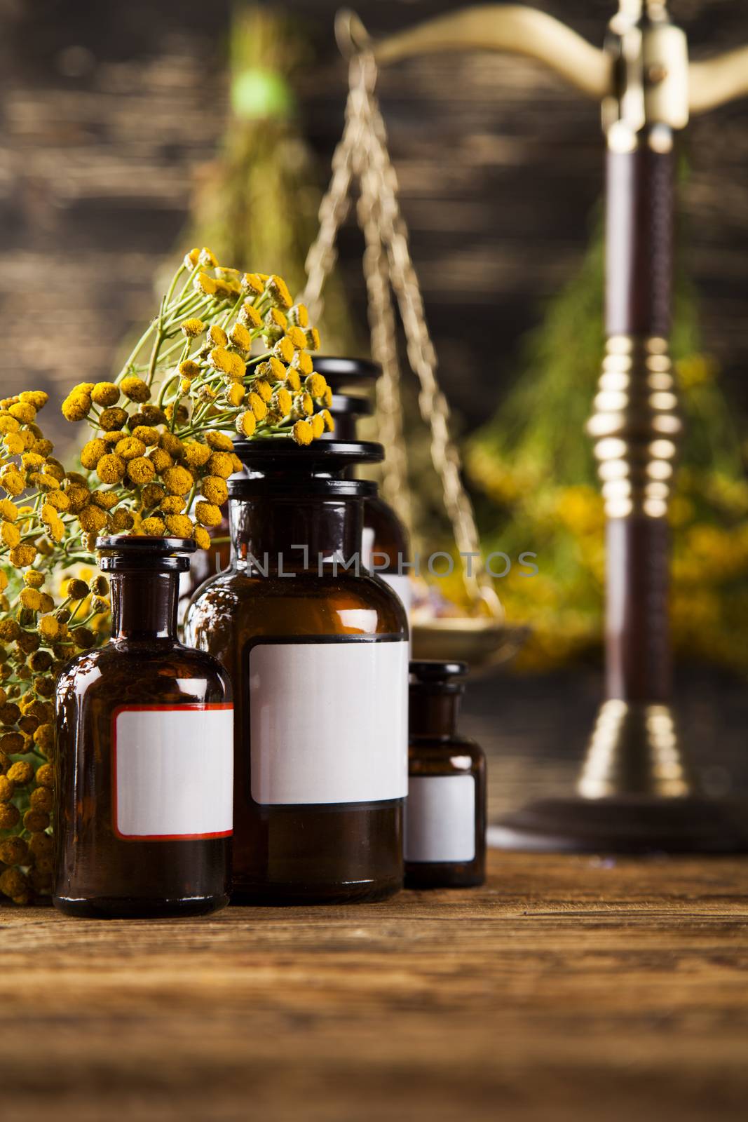 Herbal medicine on wooden desk background by JanPietruszka