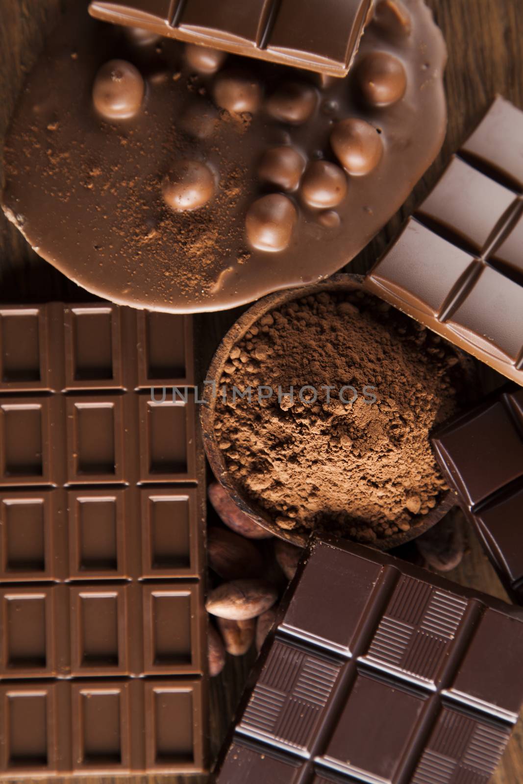 Aromatic cocoa and chocolate on wooden background