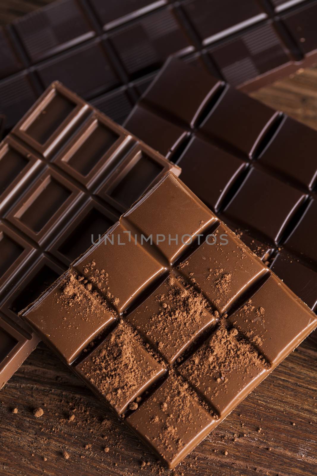 Aromatic cocoa and chocolate on wooden background