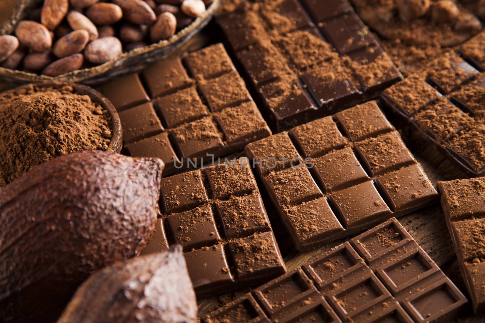 Aromatic cocoa and chocolate on wooden background