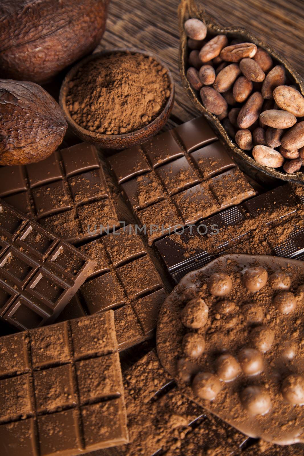 Dark and milk chocolate bar on a wooden table  by JanPietruszka