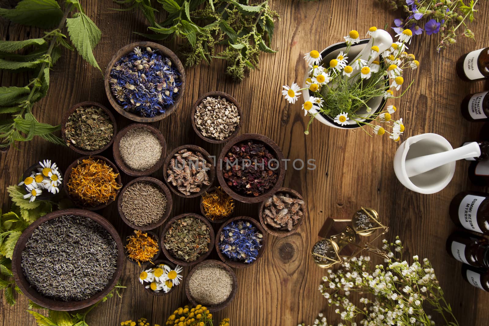 Natural medicine, herbs, mortar on wooden table background by JanPietruszka