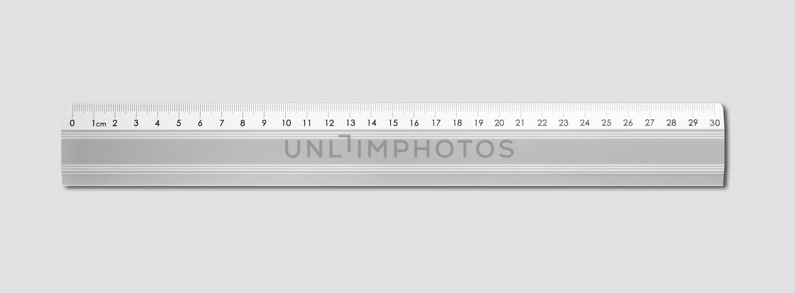 Metal ruler isolated on grey background by daboost