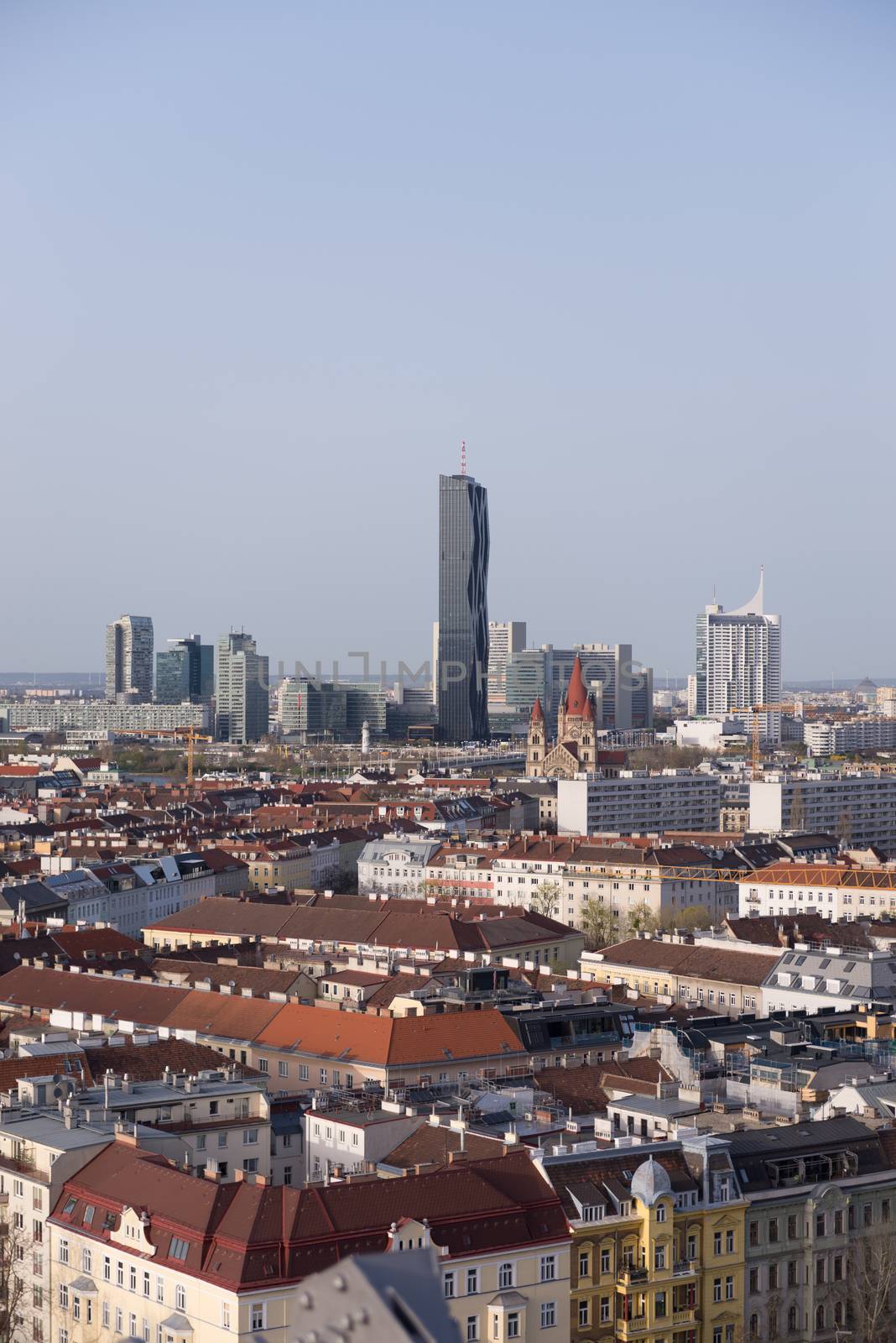 View over Vienna with skyline of Donau - Danube city centre in background, roofs of old town of Vienna in front