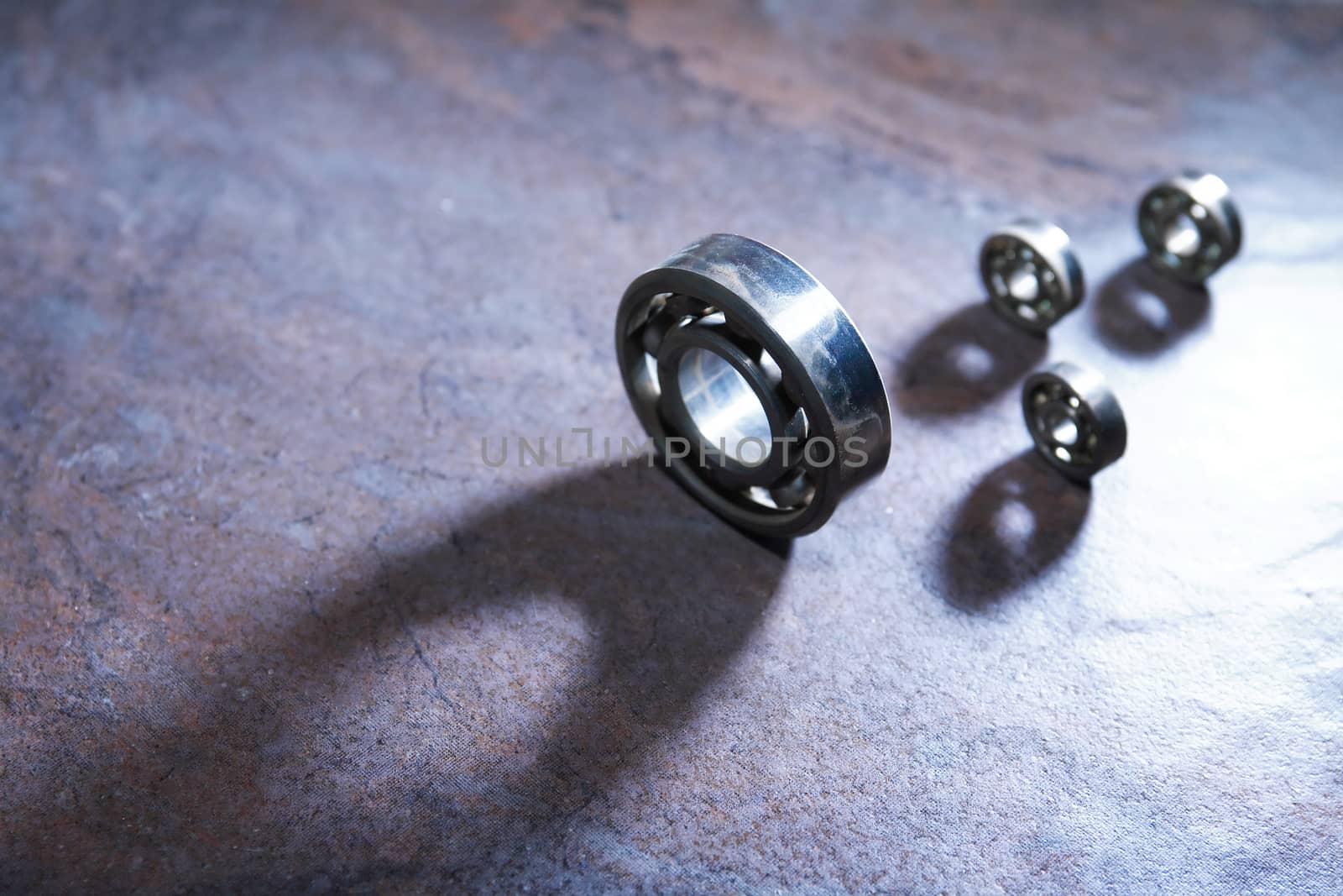 Set of  ball bearings on dark background with long shadow