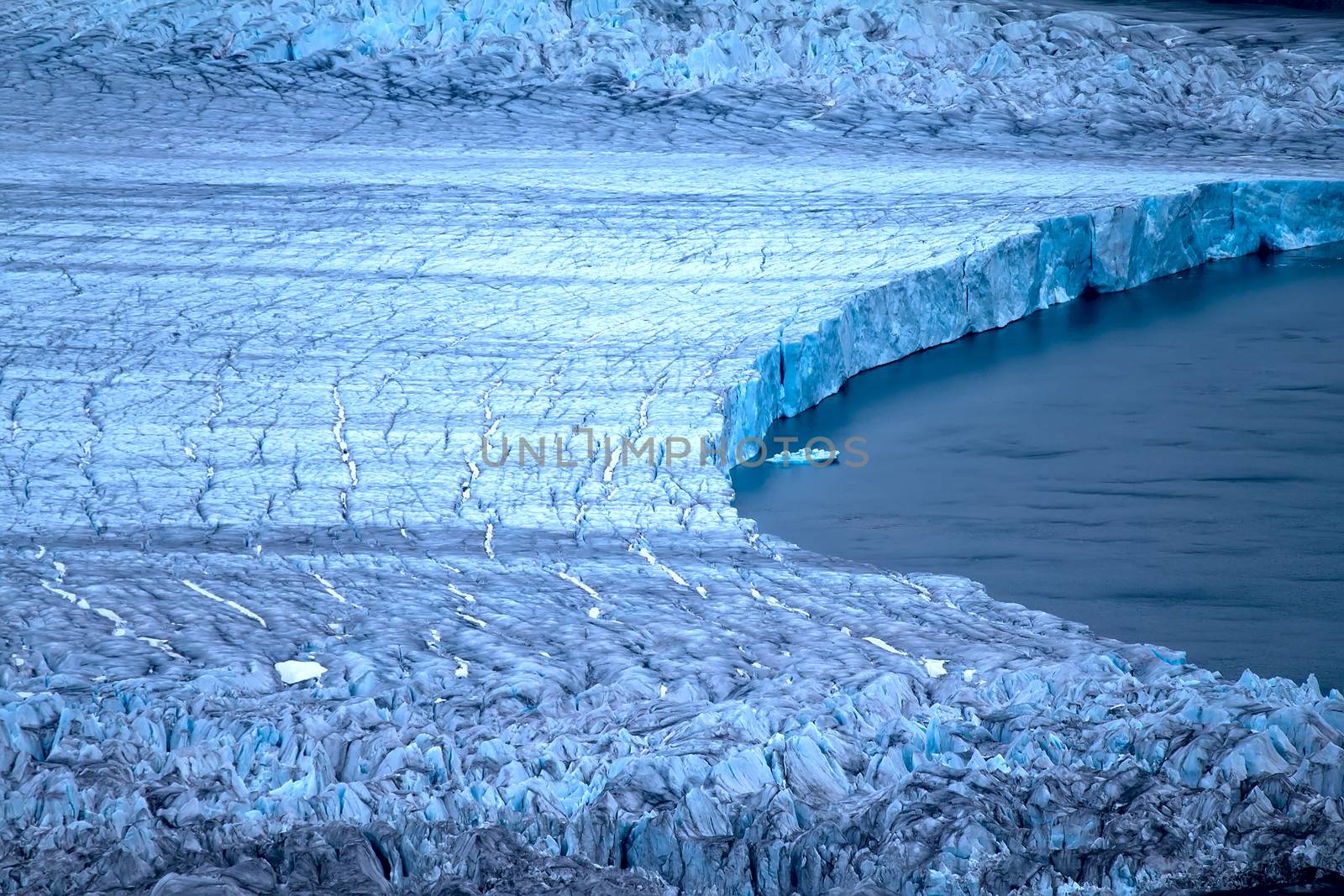 Harsh glaciers of Arctic. Live glacier: Front wall and glacial grotto. Novaya Zemlya archipelago, North island. View from helicopter