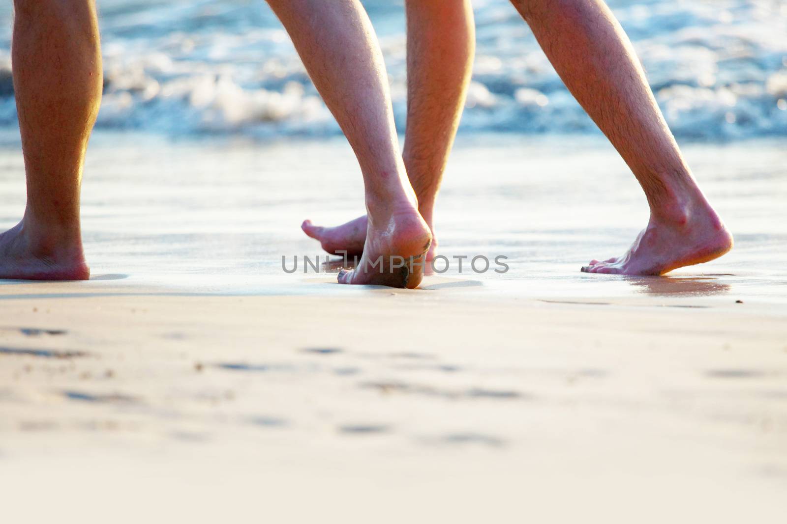 Two People walking on sandy beach, seaside vacation concept