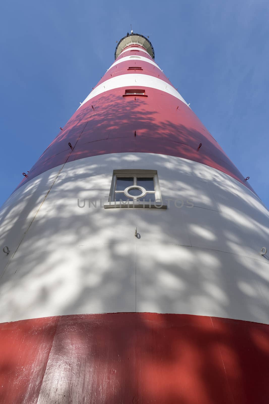 Lighthouse of the island Ameland in northern Netherlands as wide-angle shot
