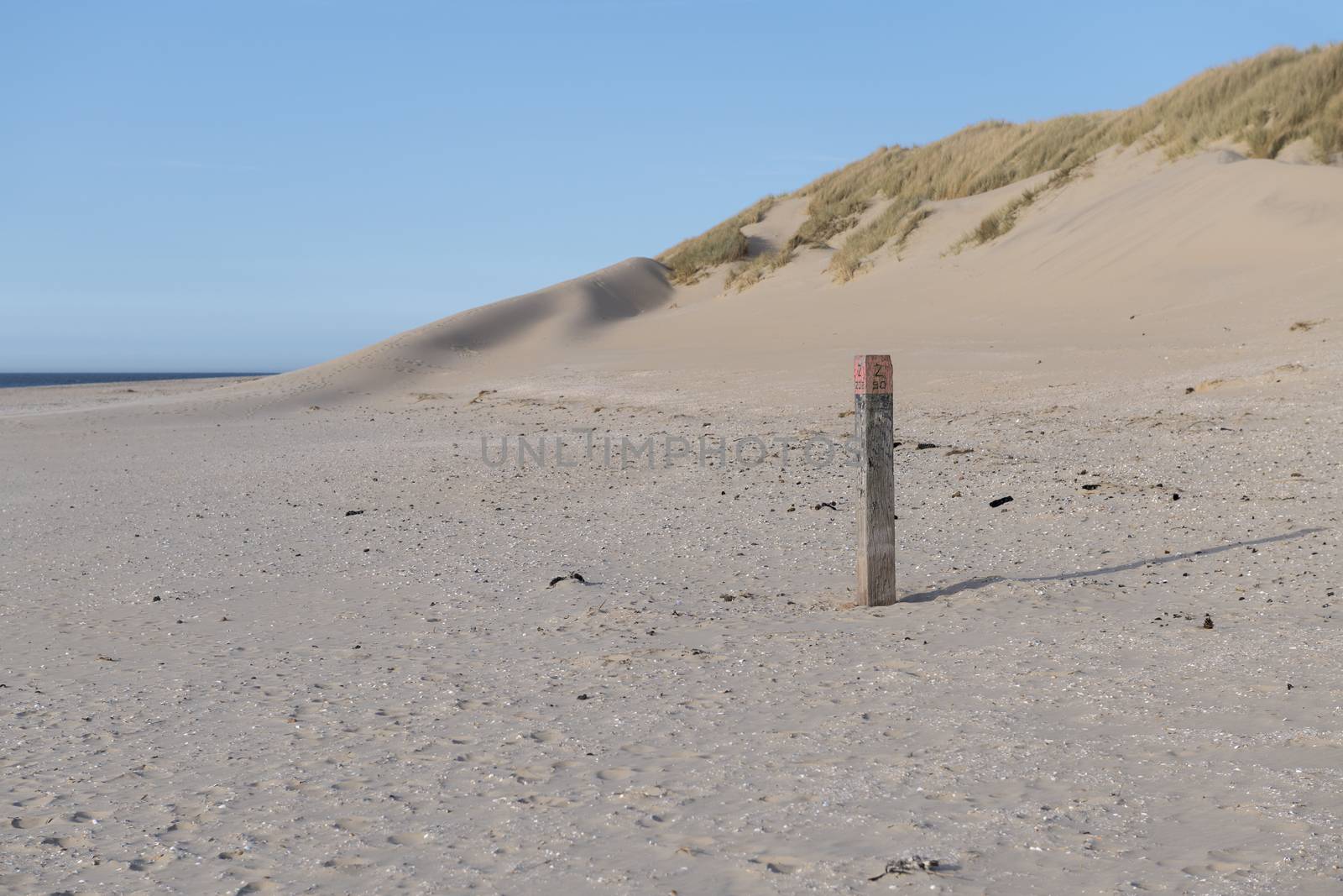 North Sea Beach on the island of Ameland with beach pole
 by Tofotografie