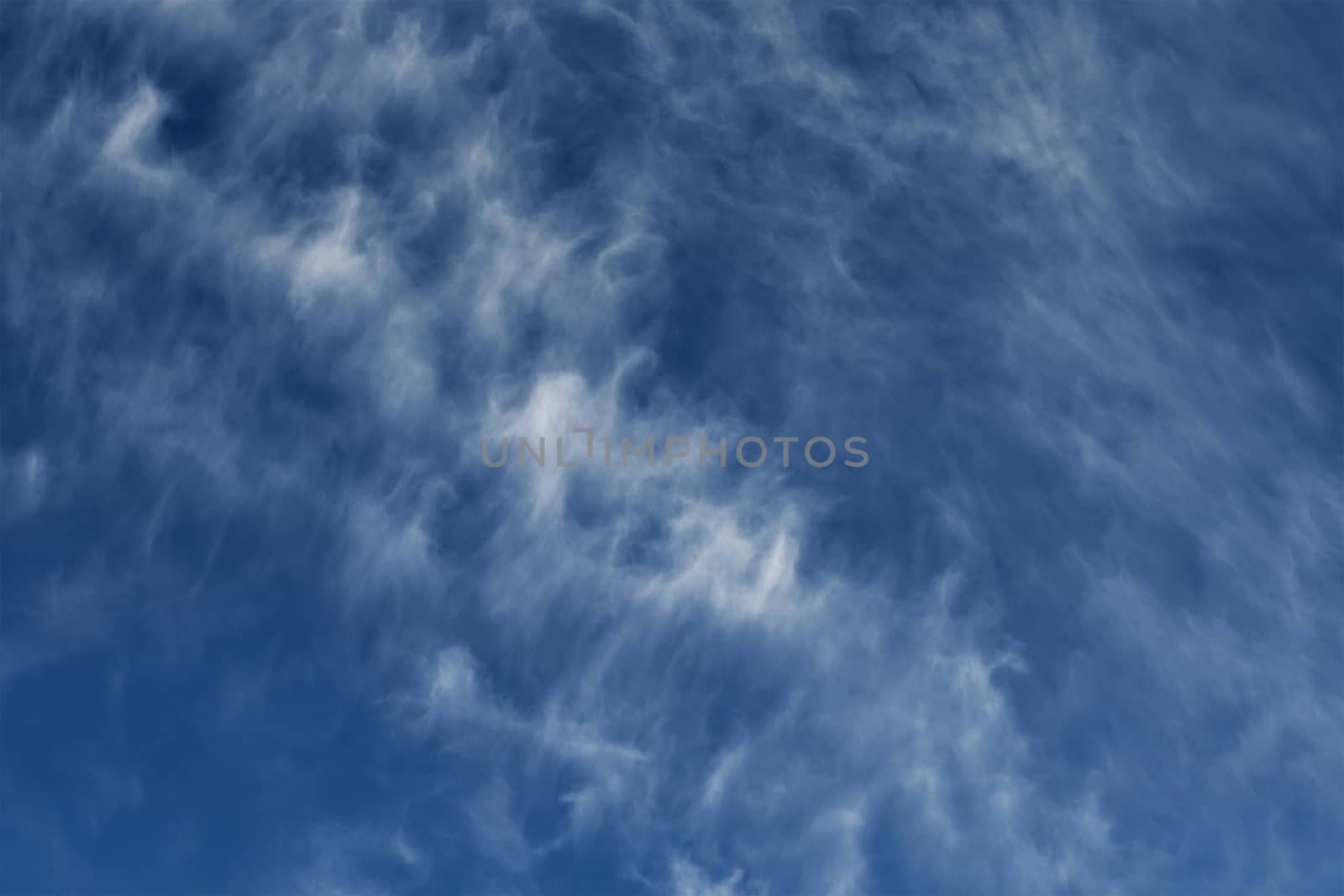 Clear blue sky with plain white cloud with space for text background. The vast blue sky and clouds