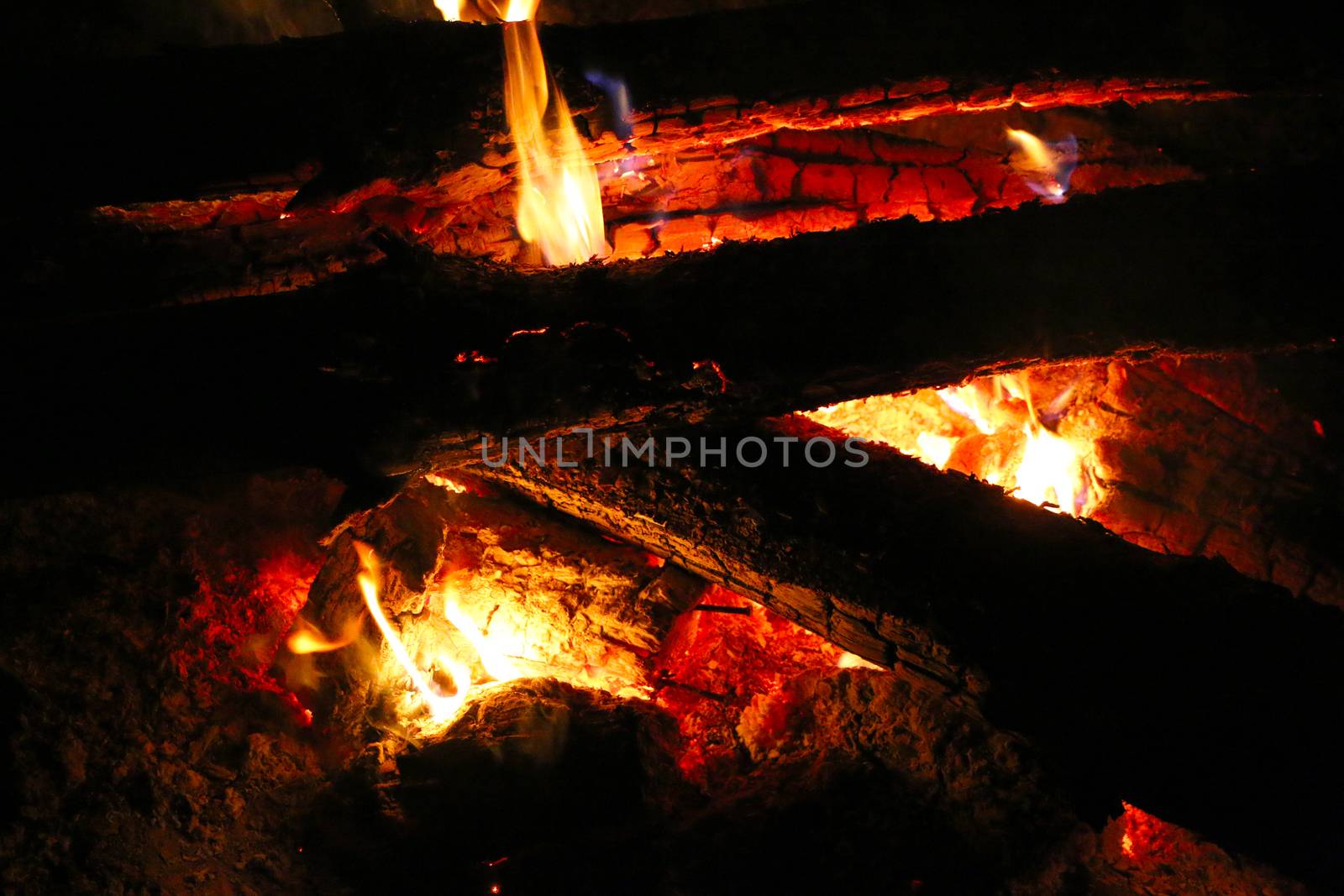 Log fire make heat ash. logs burning on fireplace in dark