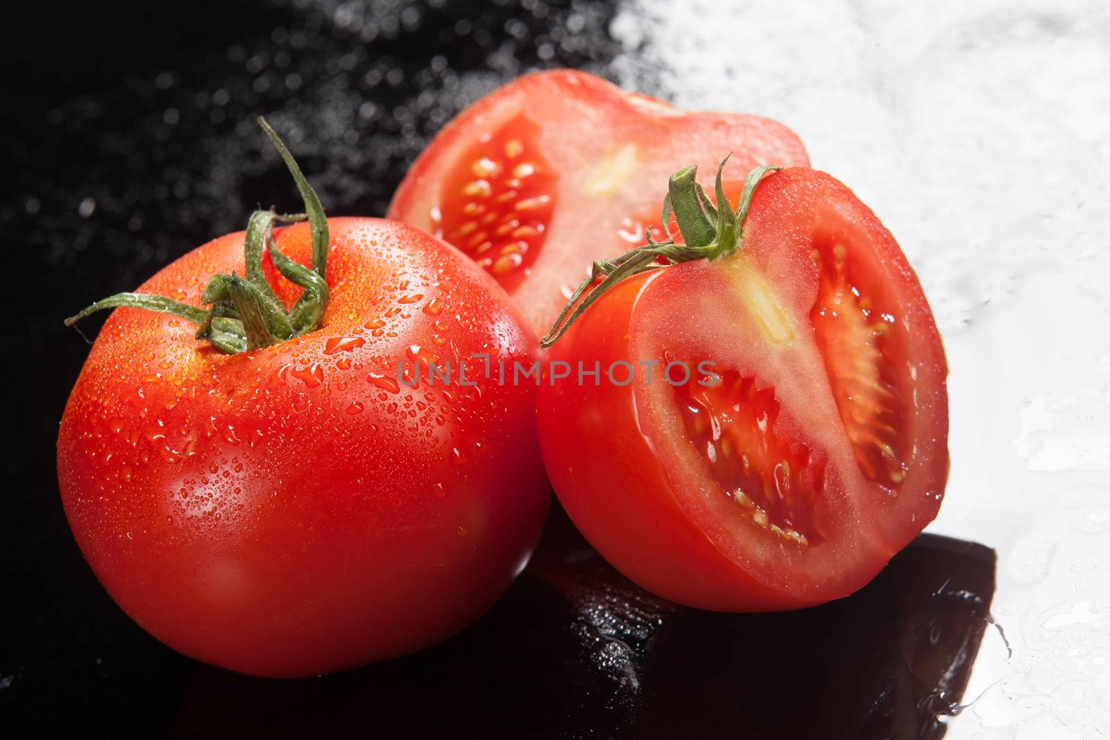 Tomatoes on a glass studio background