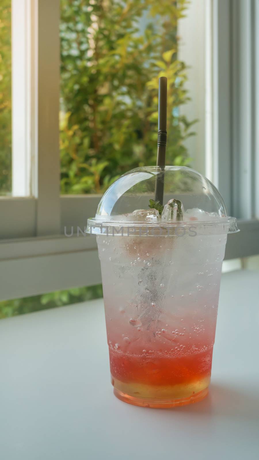 Red soda in glass put on table