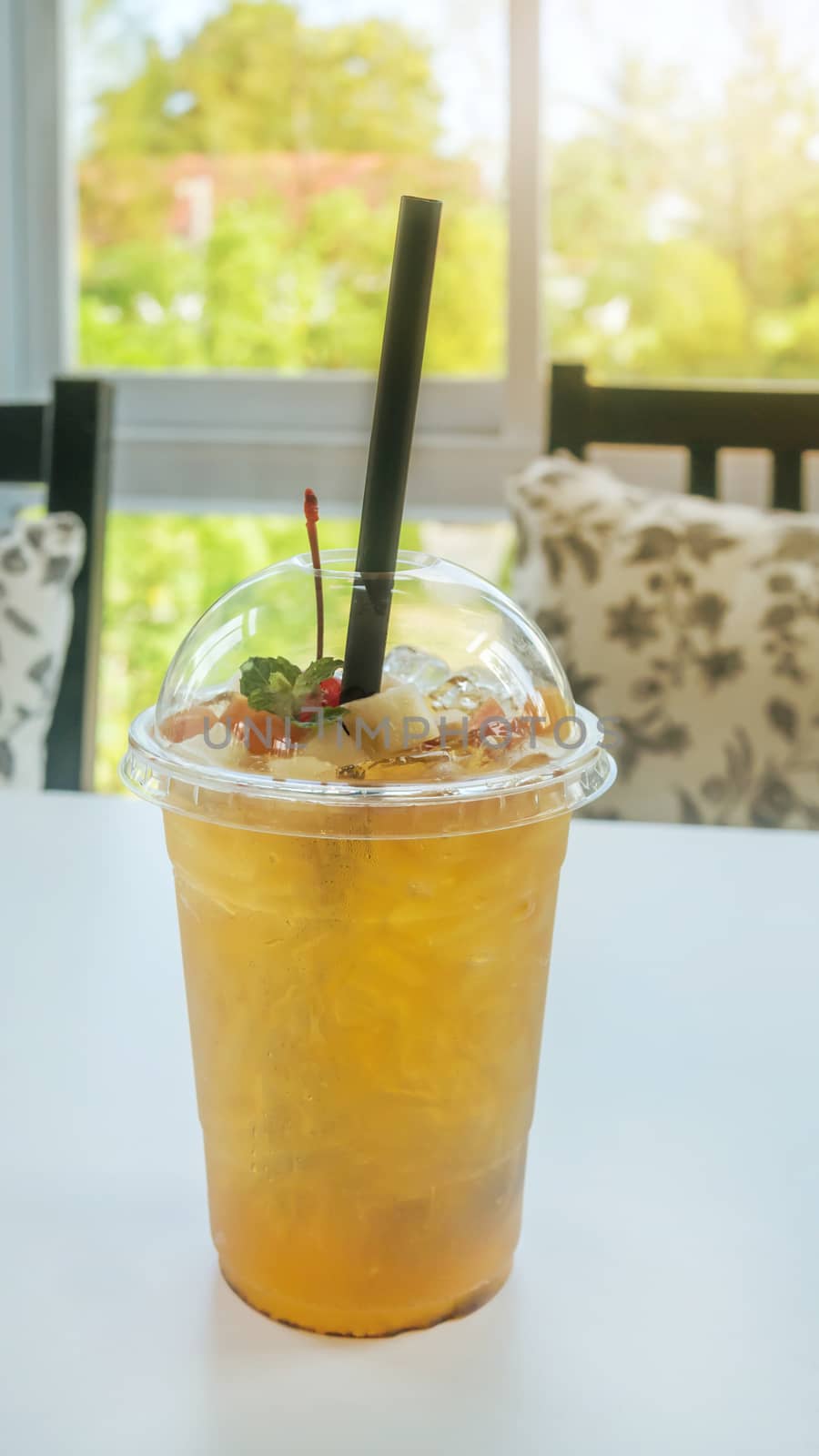 cocktail with fresh sliced fruits arranged in plastic cups