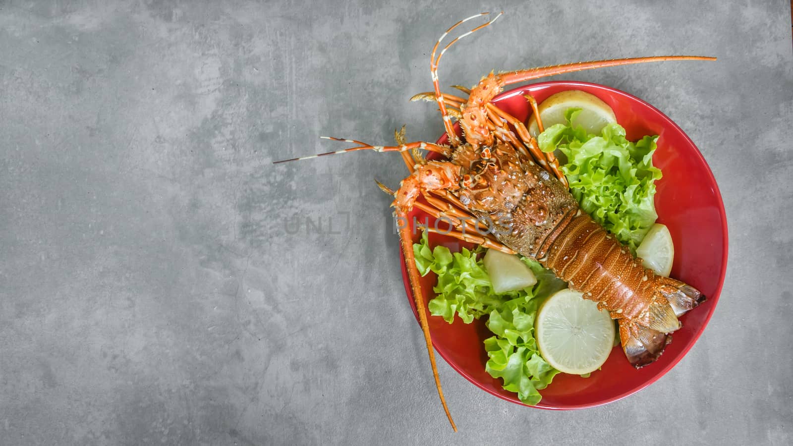 steamed lobster on plate by rakratchada
