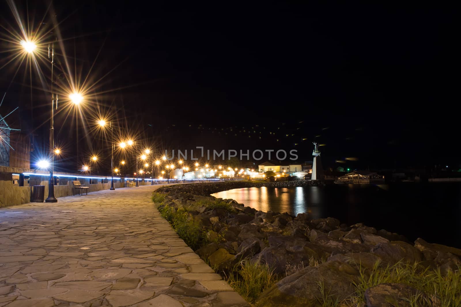 Ancient town of Nesebar UNESCO-protected. Night photography. Stone path to the beach, city lights