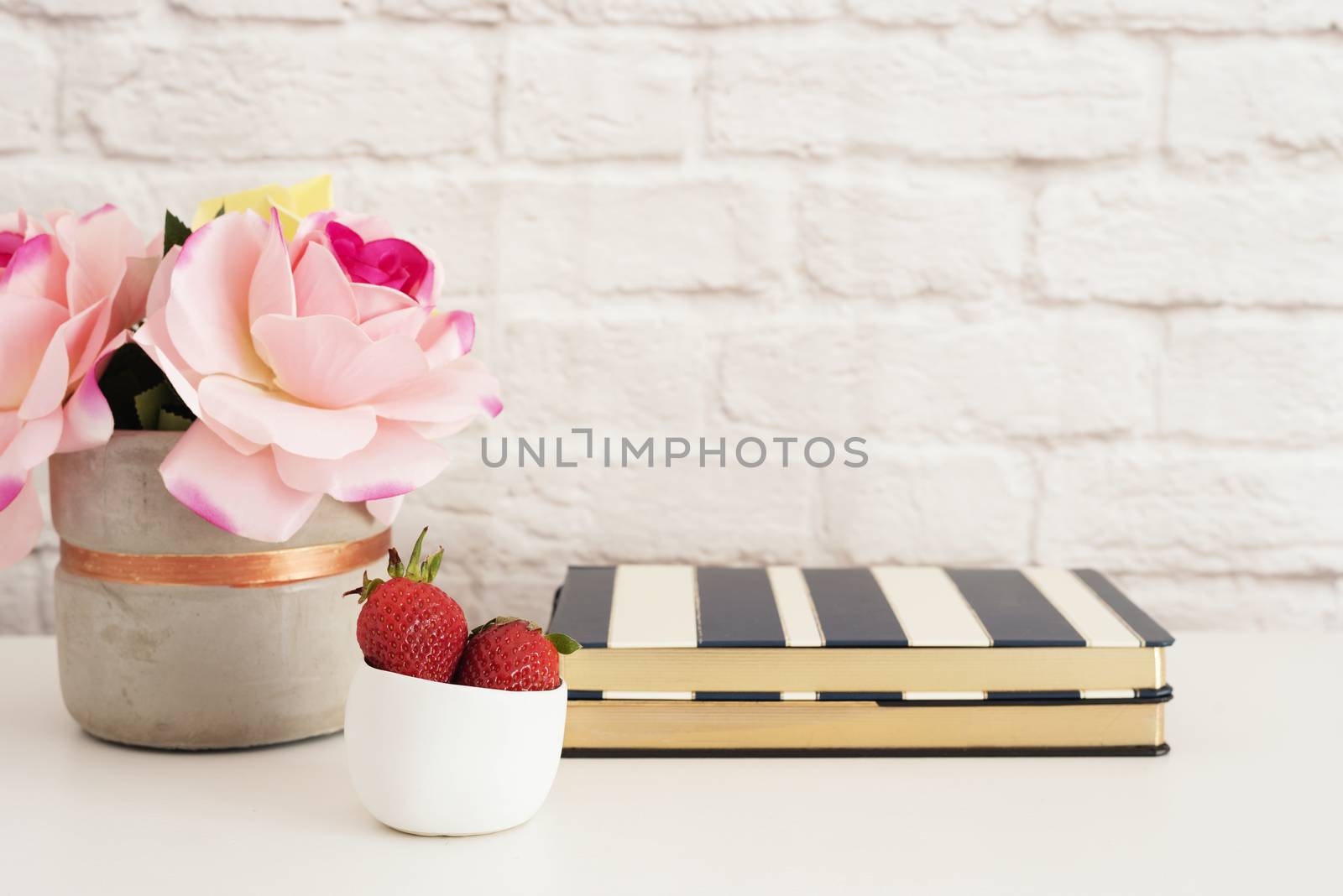 Pink Roses Mock Up. Styled Photography. Brick Wall Product Display. Strawberries On Striped Design Notebooks. Vase With Pink Roses. Fashion Lifestyle